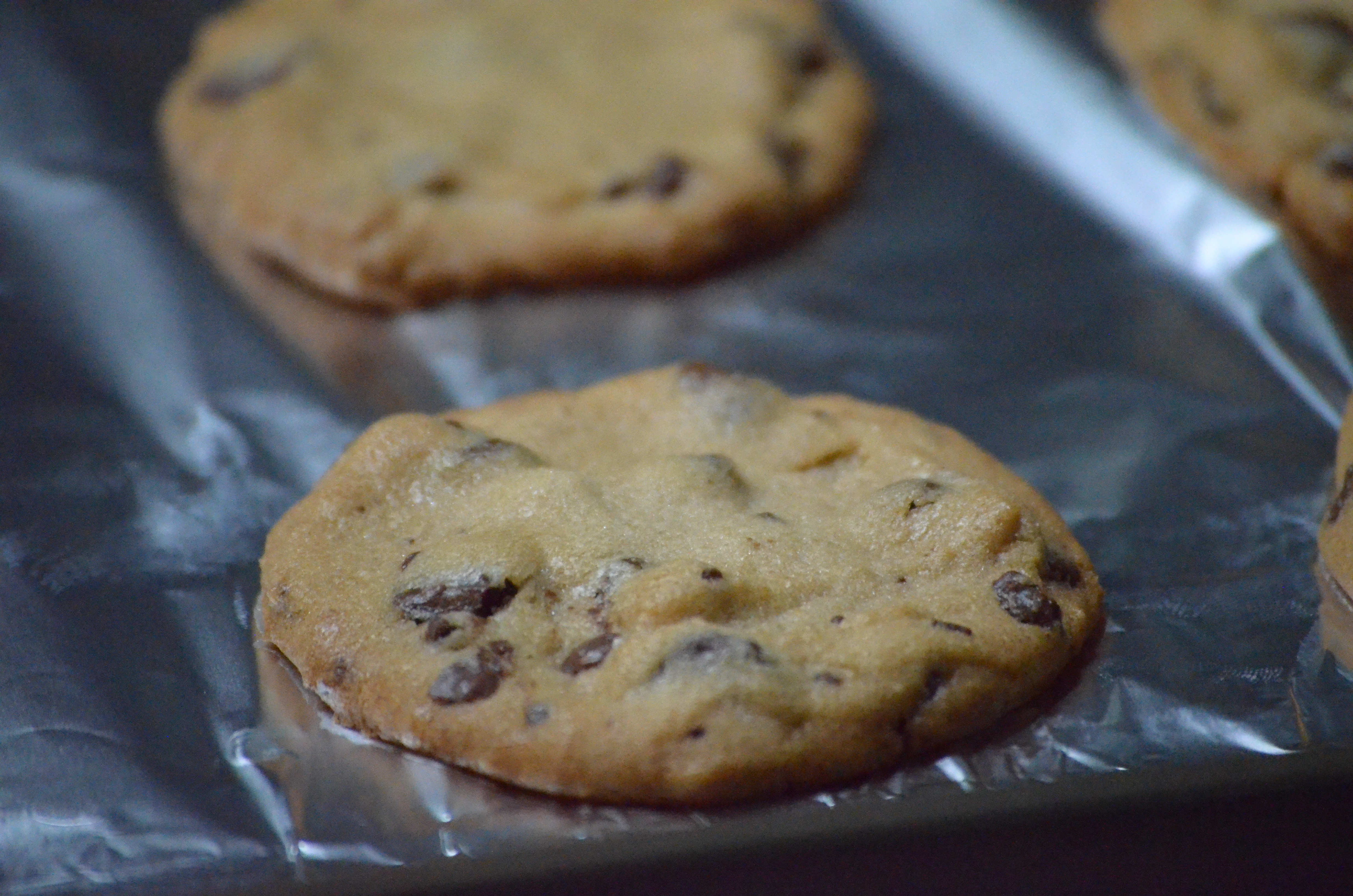 Close-up of a brown butter chocolate chip cookie, fresh off the sheet.